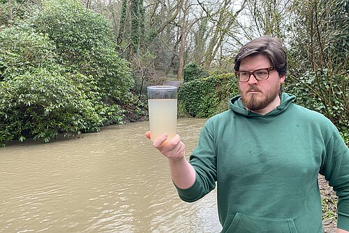 James Coles inspecting dirty water taken from the Ouseburn