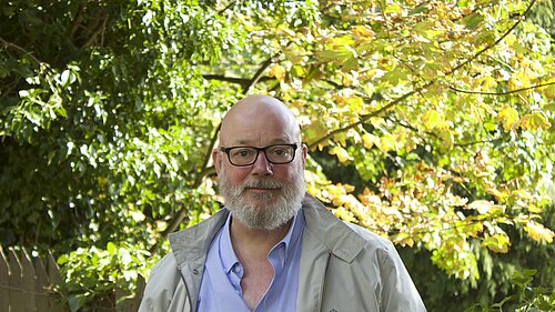 Stephen Kelly in front of trees