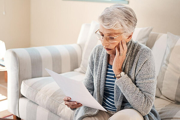 Concerned lady looking at letter