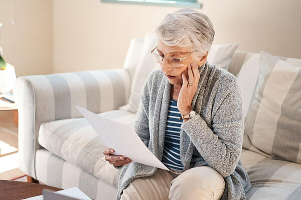 Concerned lady looking at a letter