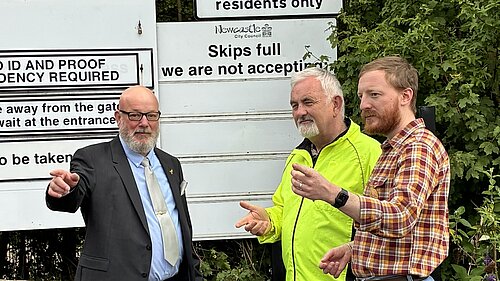 Stephen Kelly with Lib Dem colleagues in front of recycling centre entrance signs