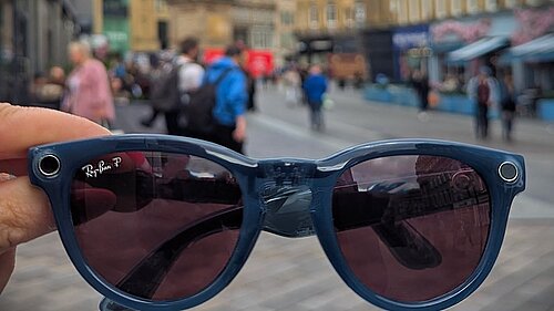 Close up picture of pair of sunglasses with Newcastle City Centre and Grey's Monument in background