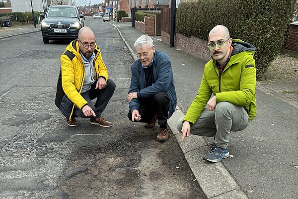Mark Mitchell, PJ Morrissey and Owen Burbidge with pothole
