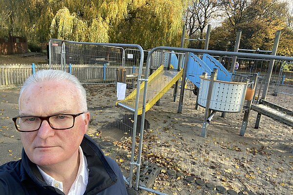Philip Browne beside fenced off play area in Exhibition Park
