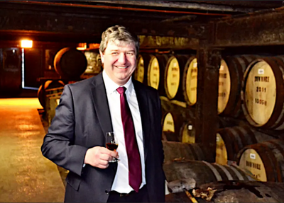 Alistair Carmichael with whisky barrels