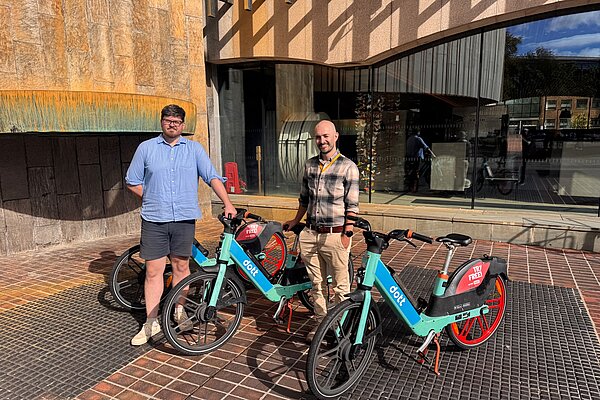 Councillors James Coles and Owen Burbidge outside Newcastle Civic Centre with Dott bikes