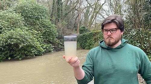 James Coles inspecting dirty water taken from the Ouseburn