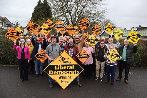 Newcastle Liberal Democrat candidates and councillors in a group photo holding up Liberal Democrat "Winning here" diamond signs 